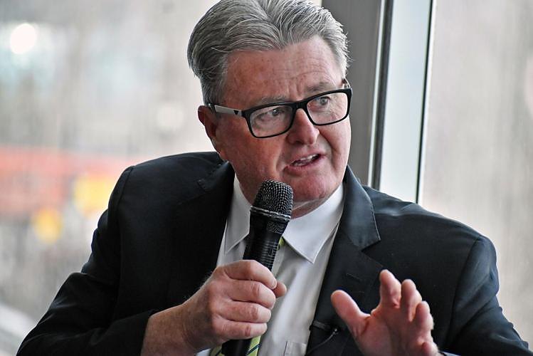 Noel Buckley speaking into a microphone at a public event